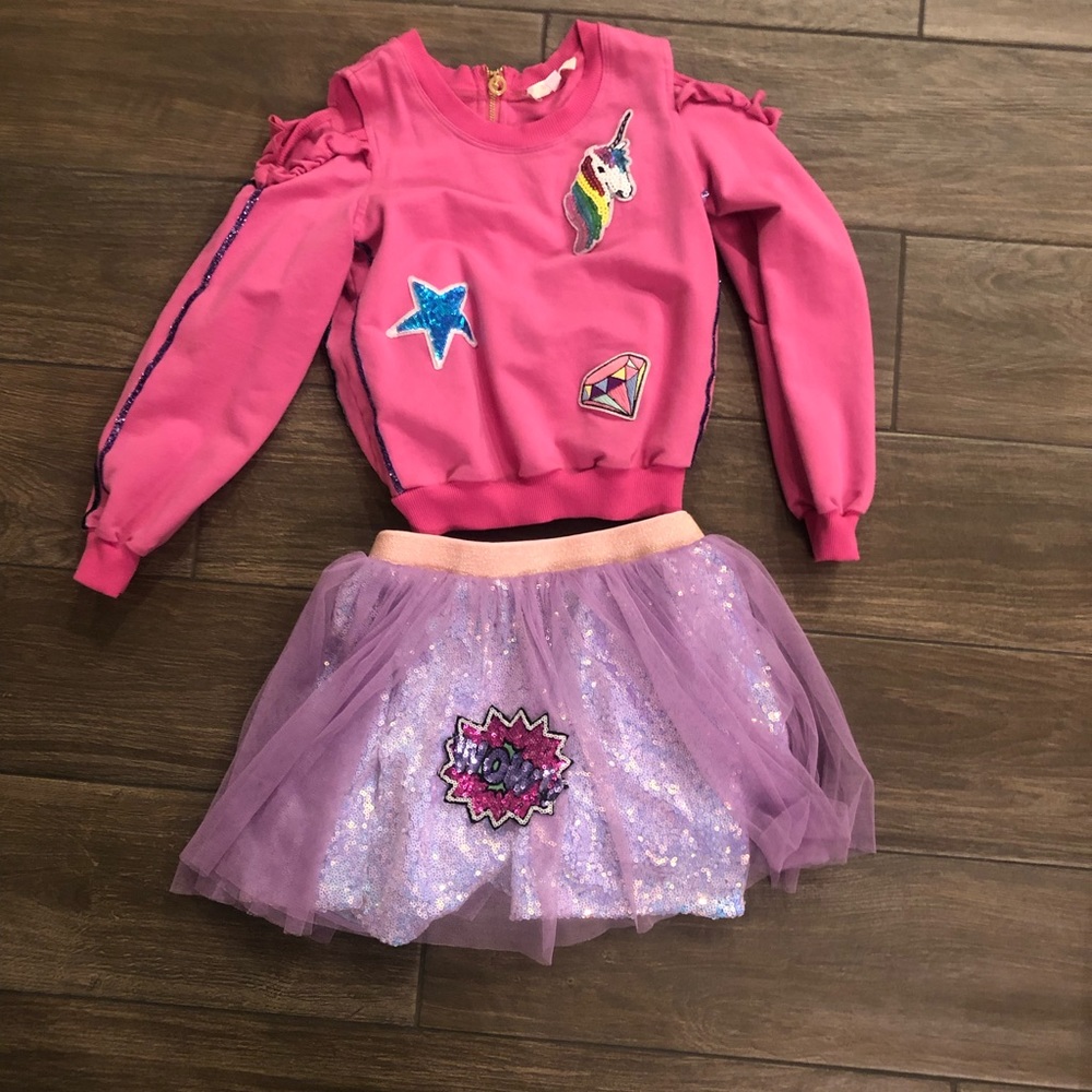 BabySara boutique brand open shoulder sweatshirt and layered sequined skirt.